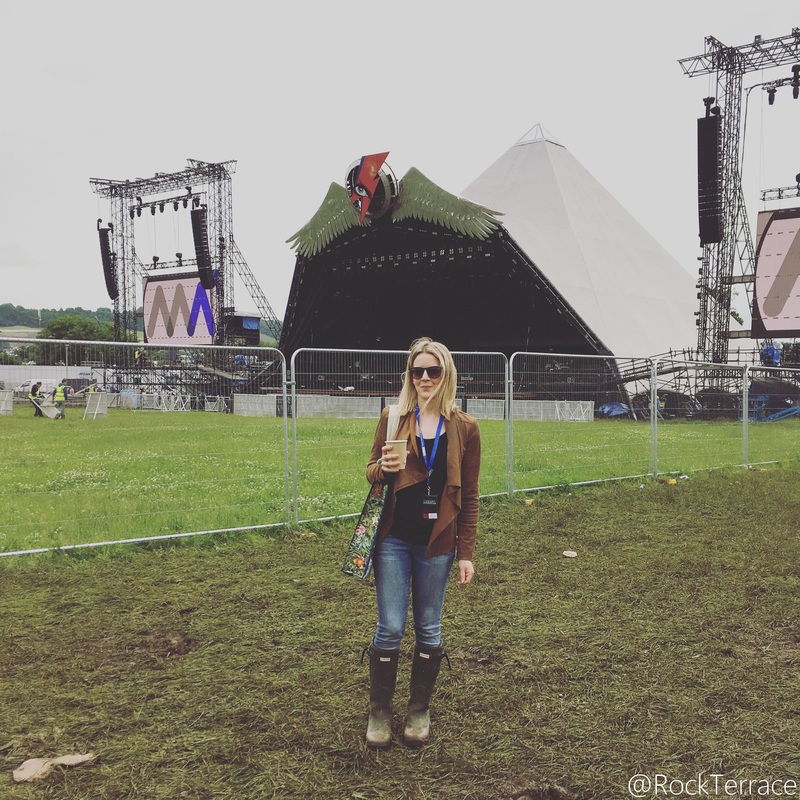 standing in front of Glastonbury Festival Pyramid stage