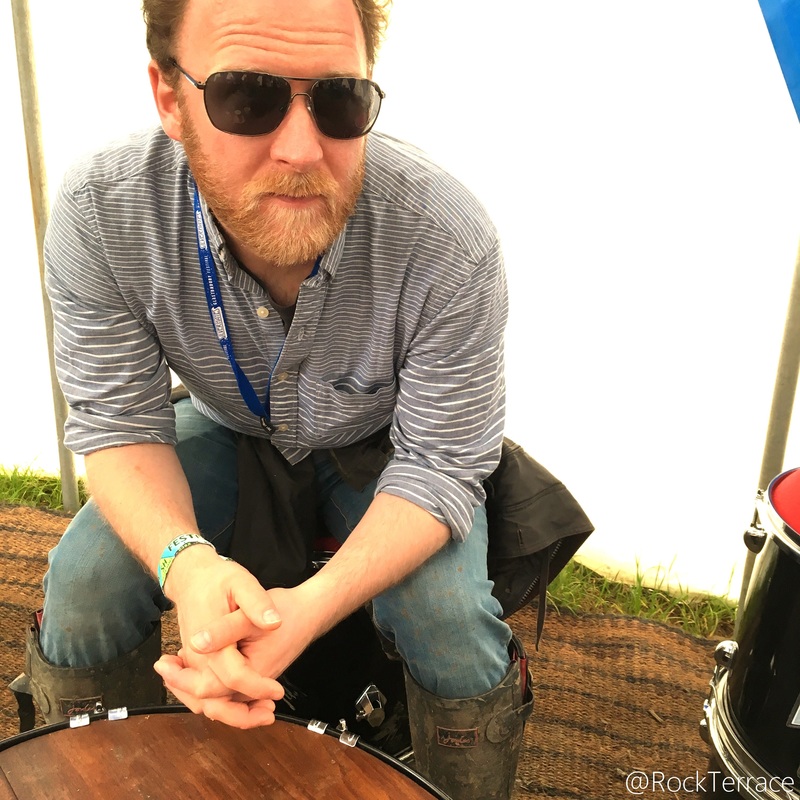 A bearded man Sam Wheeler wearing sunglasses at Glastonbury festival